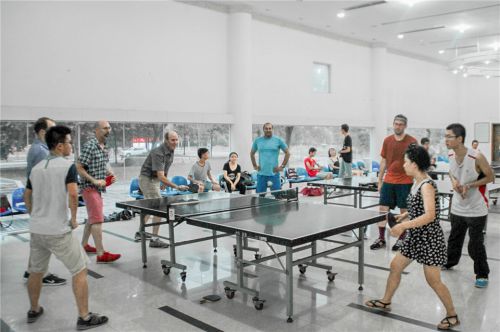 14.暑期英语口语强化班上，外教们与同学一起打乒乓球。