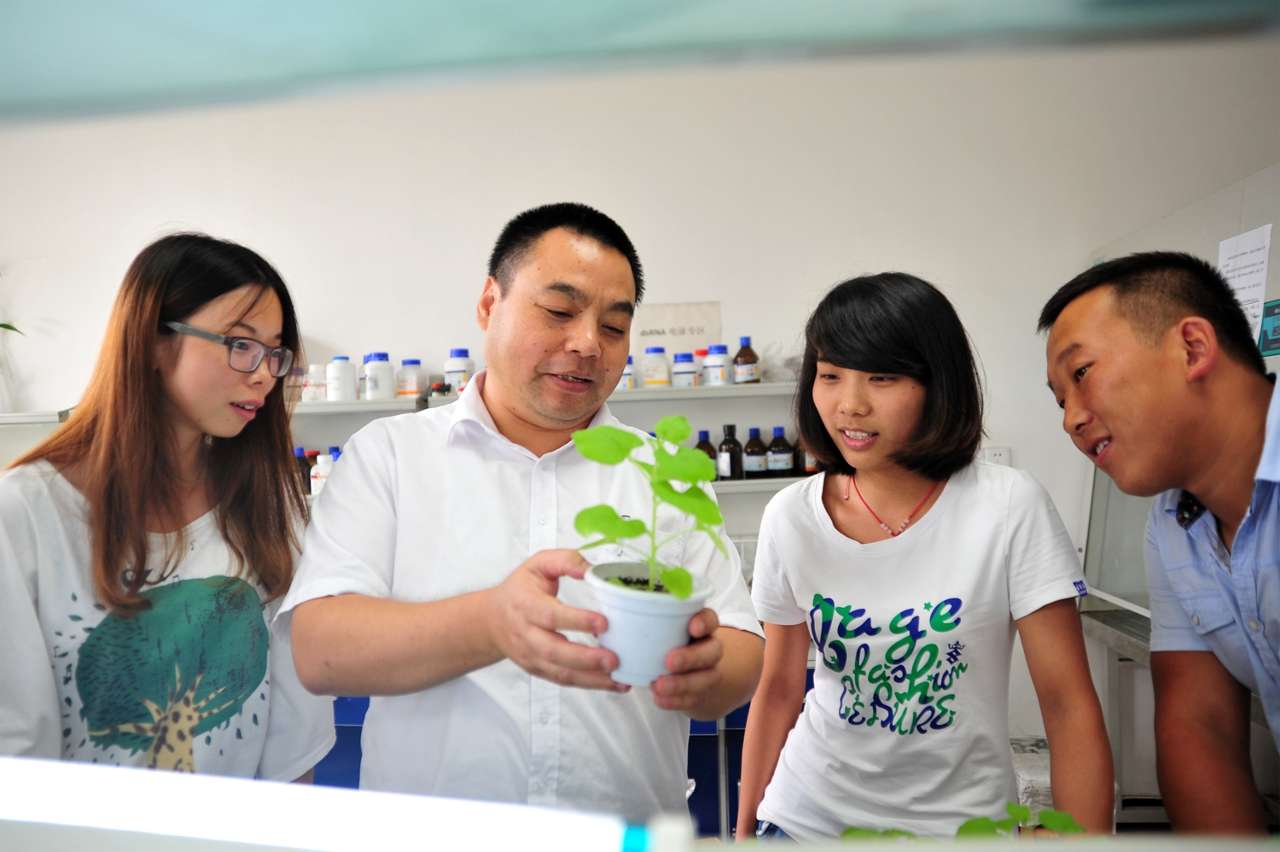 姜道宏教授与同学们一起观测植株实验情况