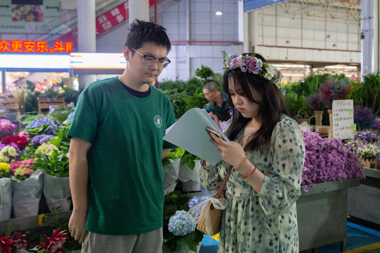 实践团队成员唐家骏在斗南花卉市场进行市场调研