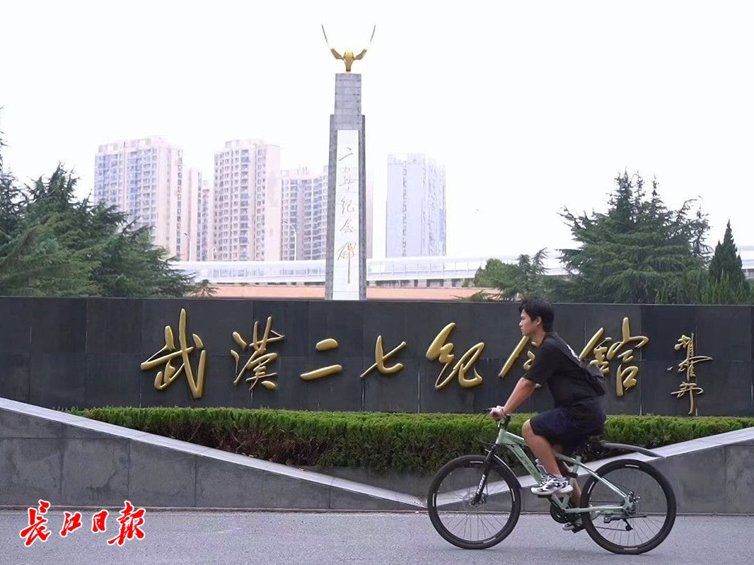 朱子健骑车经过武汉二七纪念馆(记者 肖僖 摄)